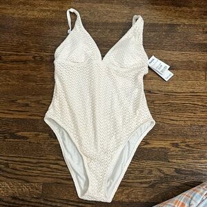 Cream knitted style one piece swim NWT. Never worn. Liner attached